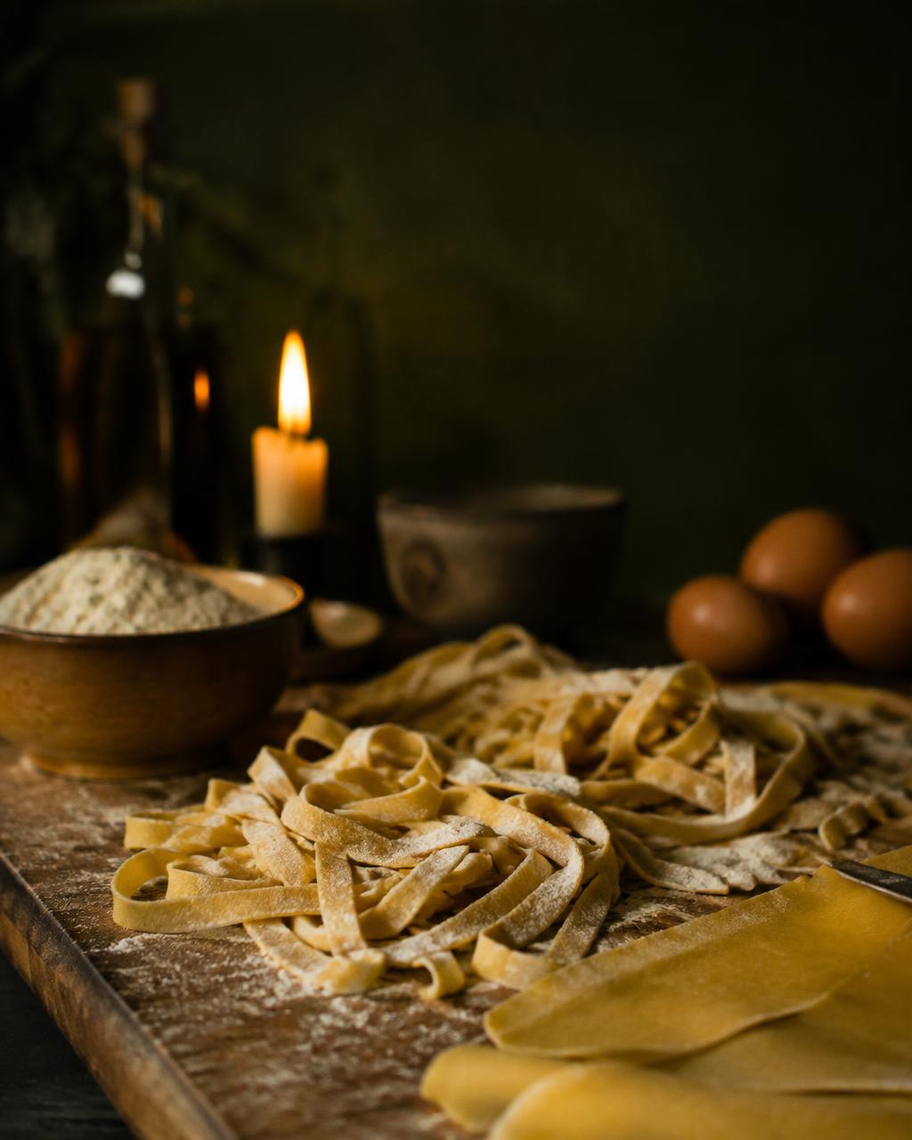 Fresh hand-cut pasta on a floured board (illustrative image)